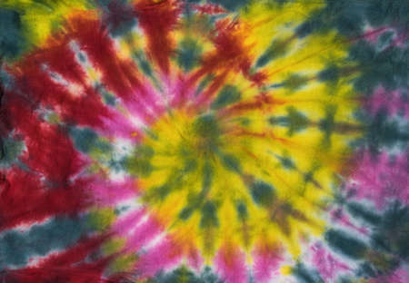 Fabric dyed with colorful beautiful tie dye style. The background on the fabric is made with your own hands. Flat lay.の写真素材