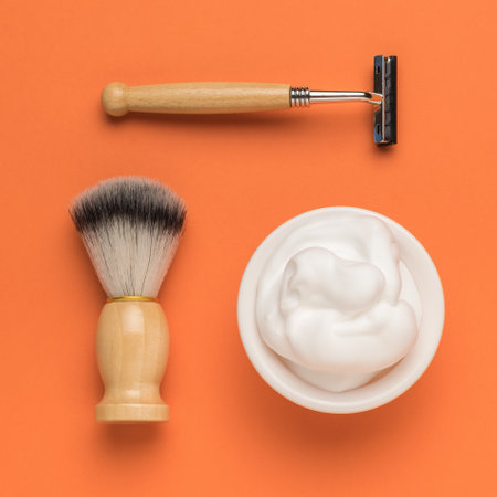 Shaving accessories made of natural materials on an orange background. Men's accessories for appearance care. Flat lay.の写真素材