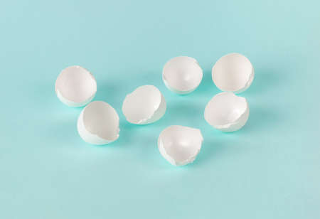 White eggshell on a light blue background. Natural products.