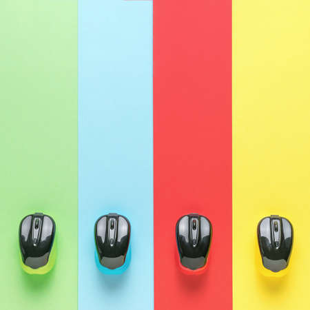 Four multicolored computer mice on four multicolored stripes. Minimal concept of wireless computer...