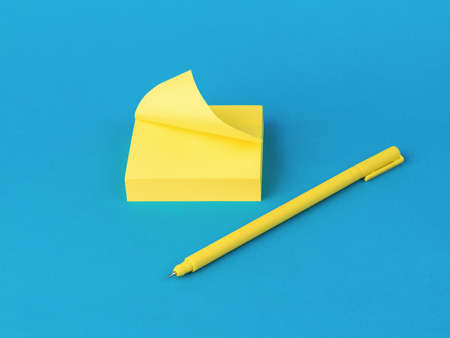 A yellow ballpoint pen and a set of yellow notes on a blue background. Stylish stationery.
