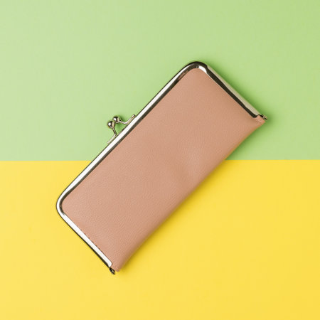 Light beige wallet on a yellow and green background. The concept of the family budget. flat lay. Place for text.の写真素材