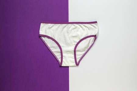 White and purple women's underpants on a white and purple background. Women's underwear. flat lay.の写真素材