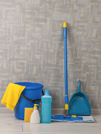 Cleaning kit near the wall in the room on the floor. Home and office cleaning kit. The concept of...
