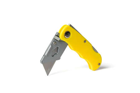 Yellow folding knife for cutting insulated on a white background. manual cutting tool.