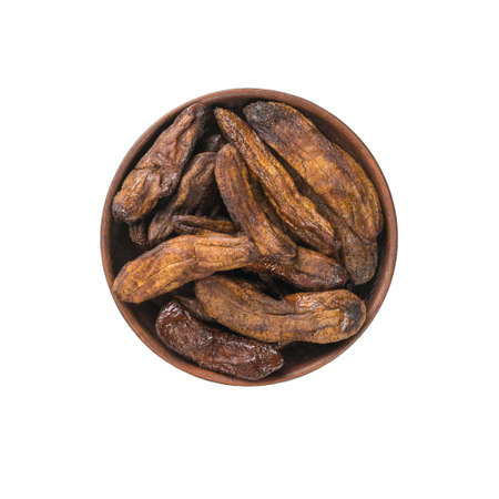 Clay bowl with dried banana isolated on a white background. Delicious natural fruit snack. flat lay.の写真素材
