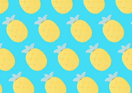A pattern of pineapple figures on a light blue background. Minimal summer concept.の写真素材