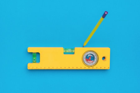 Yellow pencil marking marks on the yellow level. Minimal concept of construction and repair.