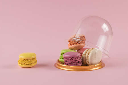 An open flask with macaroni cookies on a pink background. A popular sweet treat.の写真素材