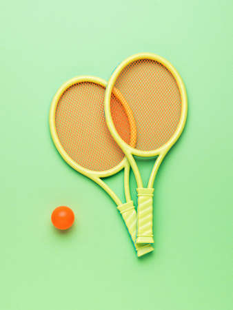 Two rackets and a ball on a blue background. Minimal sports concept. flat lay.の写真素材