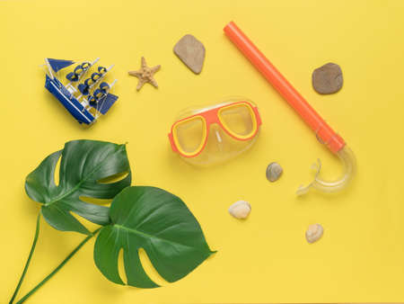 Accessories for scuba diving on a yellow background. Minimal concept of scuba diving and summer recreation. flat lay.の写真素材