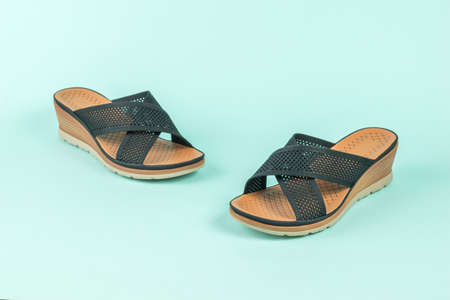 Women's summer shoes with solid soles on a blue background. Minimal summer concept.の写真素材