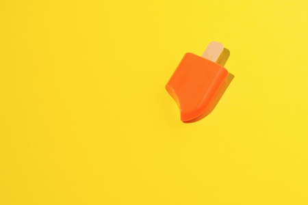 Bright frozen juice on a bright yellow background. A popular summer snack. ice creamの写真素材