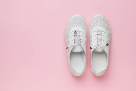 Summer women's sports style shoes on a pink background. Minimal concept of beauty and sports. flat lay.の写真素材