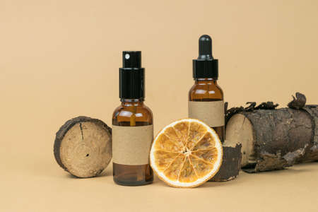 Scraps of old wood, bottles and dried orange on a beige background. The concept of treatment and body care using natural remedies.の写真素材