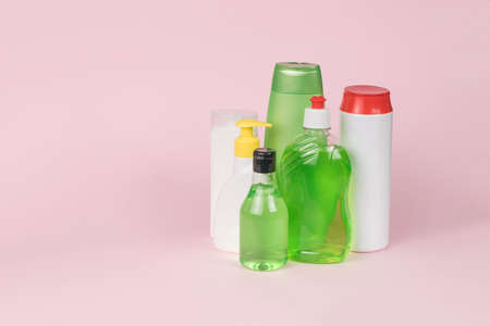 Several bottles of detergent on a pink background. cleaning kit.の写真素材