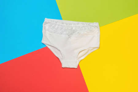 High white panties on a background of four colors. Minimal concept of women's underwear. flat lay.の写真素材