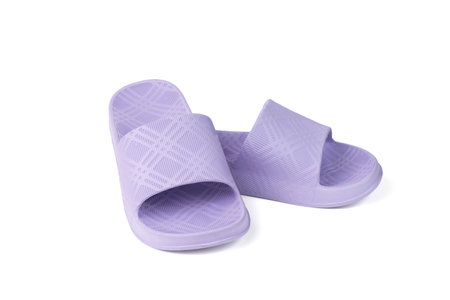 Women's purple rubber flip-flops isolated on a white background. The concept of summer women's shoes.の写真素材