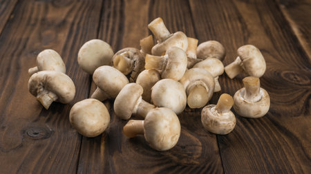 A bunch of fresh mushrooms on a rustic background. Delicious and healthy mushrooms.の写真素材