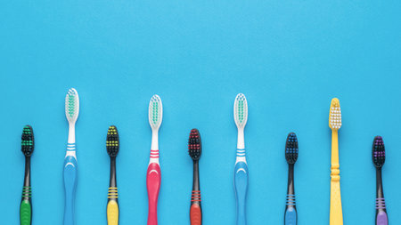 Plastic toothbrushes on a light pink background. Minimal oral care concept. flat lay.の写真素材