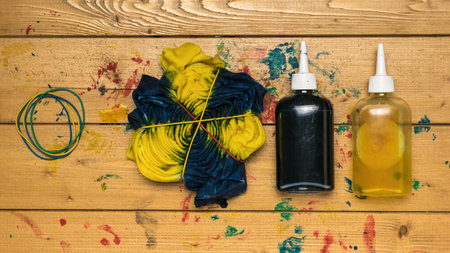 Blue and yellow tie dye T-shirt, recently dyed. The process of painting in the style of tie dye. flat lay.の写真素材