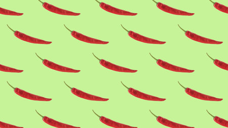 Seamless pattern of red pepper on a green background. The minimal concept of a popular seasoning. A popular spice. flat lay.の写真素材