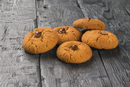 A few pieces of oatmeal cookies on a wooden table. Minimal concept of home baking.の写真素材