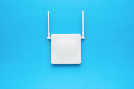 Wi-Fi router with two antennas on the blue screen. The concept of wireless data transmission. Flat lay.の写真素材