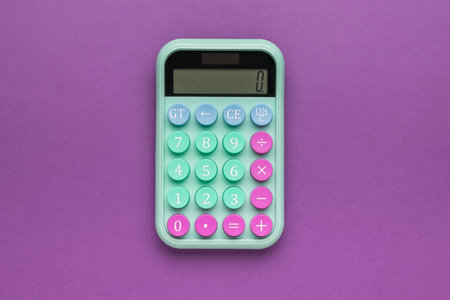 Calculator with big round buttons on a green background. The concept of financial accounting. Flat lay.の写真素材