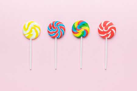 A set of lollipops on a pink background. The concept of sweets. Flat lay.の写真素材