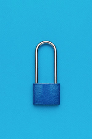 Closed blue metal lock on a blue background. The concept of protection.の写真素材