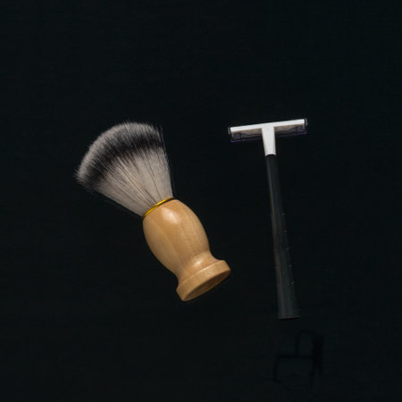 A shaving brush and a man's razor on a black background. The concept of men's shaving.の写真素材