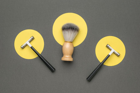 A brush and two razors on an abstract background. The concept of men's shaving.の写真素材