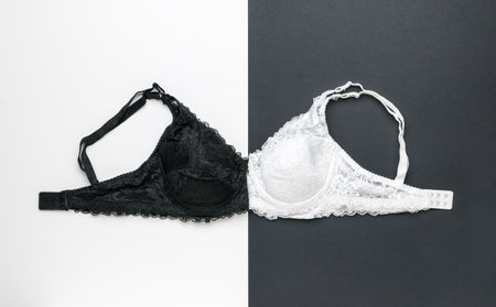 Black and white women's bras on a black and white background. The concept of women's underwear.の写真素材