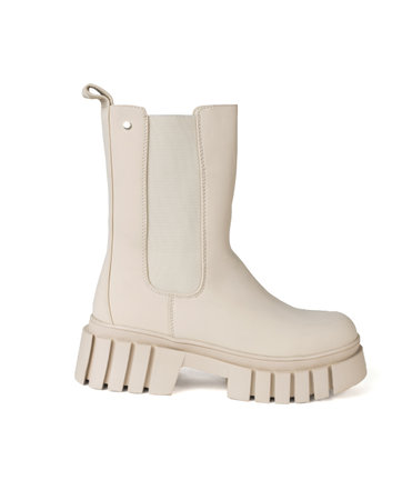 Women's beige ankle boots isolated on a white background. The concept of women's shoes for cold weather.の写真素材