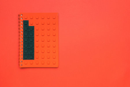 Red notebook constructor on a red background. Stylish stationery.