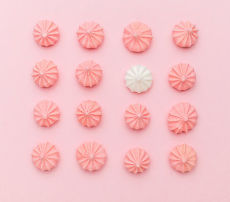Pink and white meringue on a light pink background. A sweet dish.の写真素材