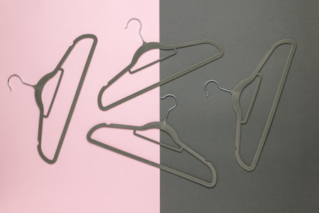 A set of hangers on a pink and gray background. An accessory for storing clothes.の写真素材