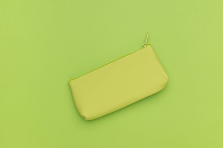 Stylish green women's wallet on a green background. A stylish women's accessory.の写真素材