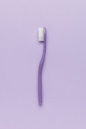 A purple toothbrush on a purple background. The concept of oral care.の写真素材
