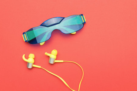 Yellow headphones and blue sunglasses. The minimal concept of fashion accessories.の写真素材
