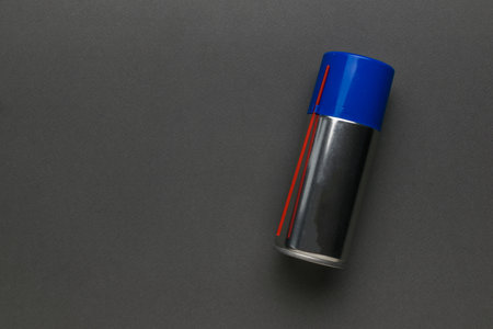 A closed aerosol can on a gray background. A means for lubricating mechanisms.の写真素材