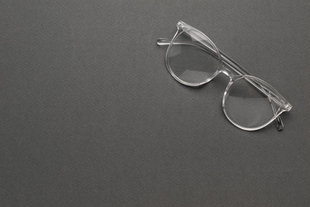 Top view of transparent glasses on a gray background. A fashionable tool for vision correction.の写真素材
