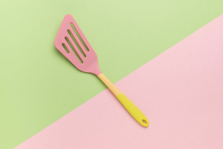 Two-tone kitchen silicone spatula on a two-tone background. Creative kitchen utensils.の写真素材