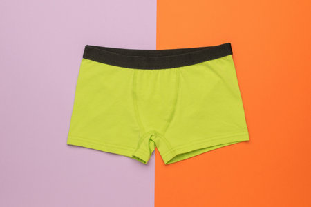 Bright men's green underpants on a bright two-tone background. Men's underwear.の写真素材