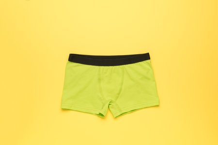 Light green men's underpants on a yellow background. Men's underwear.の写真素材