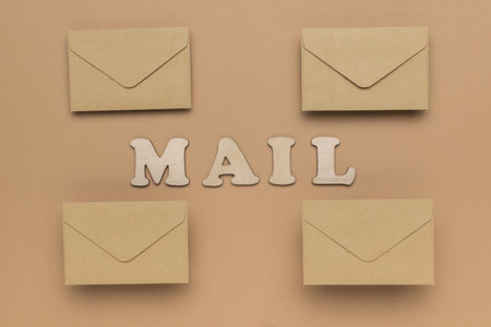 Postal envelopes and the inscription mail on a brown background. The concept of communication through correspondence.の写真素材