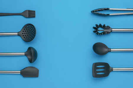 Minimalist Kitchen Utensils on Blue Background - Modern Cooking Tools and Essentialsの写真素材