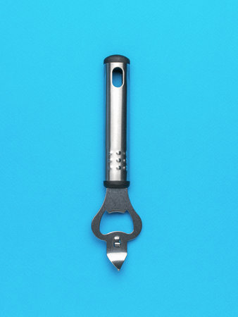 Stainless Steel Bottle Opener Against Solid Blue Backgroundの写真素材