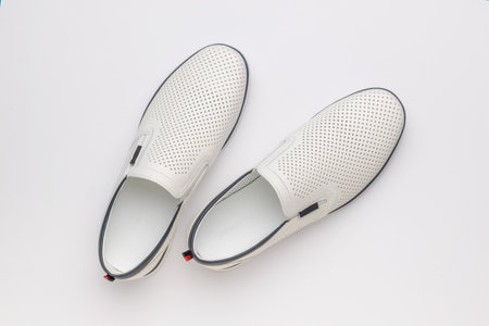 Minimalist White Leather Slip-On Shoes on Clean Background - Fashion Footwear Photographyの写真素材
